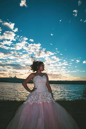 clothing woman in white and pink sweetheart neckline gown by the sea apparel
